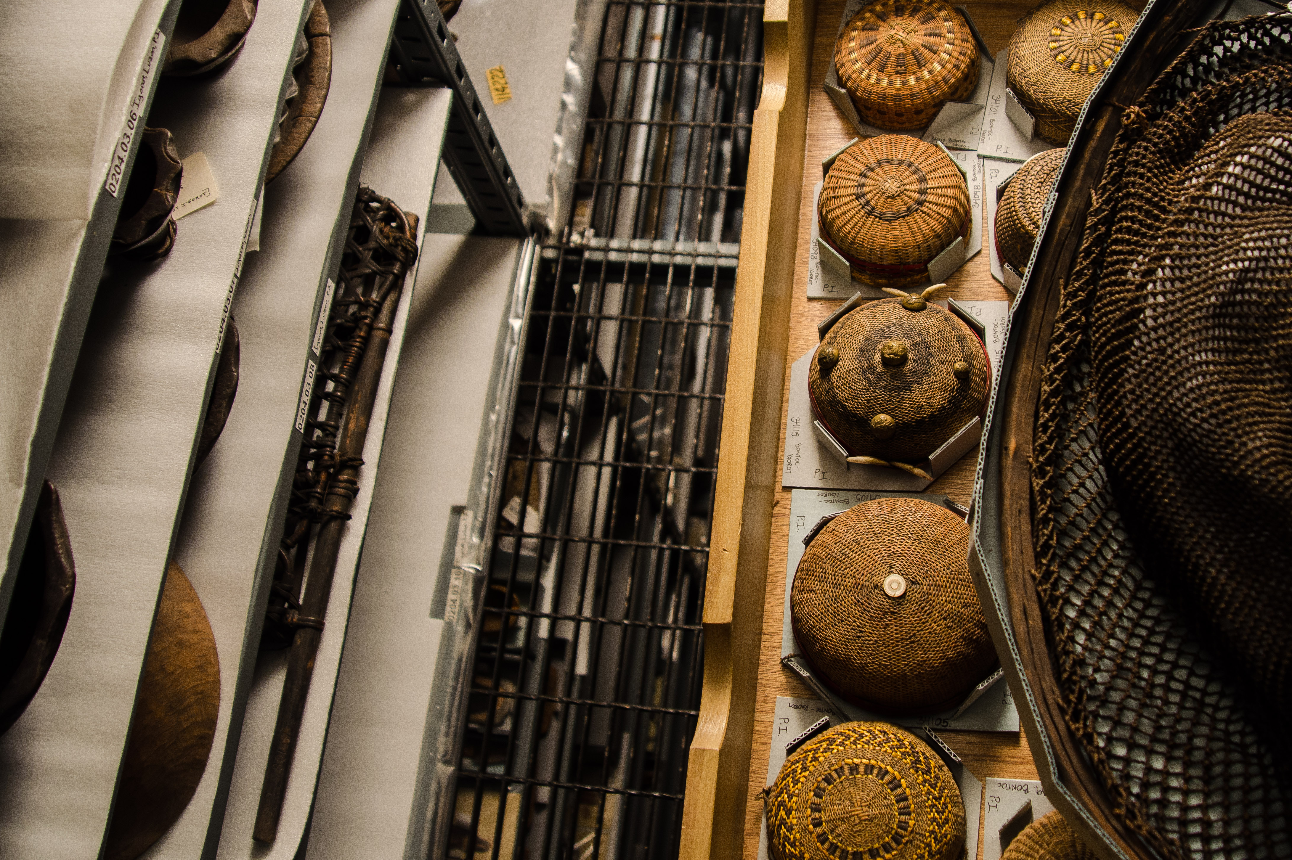 Image depicting ariel view of pocket hats and fishing net in the collections at their storage designations within CAS Mezzanine storeroom. Selected for use on the homepage of the Philippine Heritage Collections interactive web portal. (c) Field Museum of Natural History - CC BY-NC 4.0