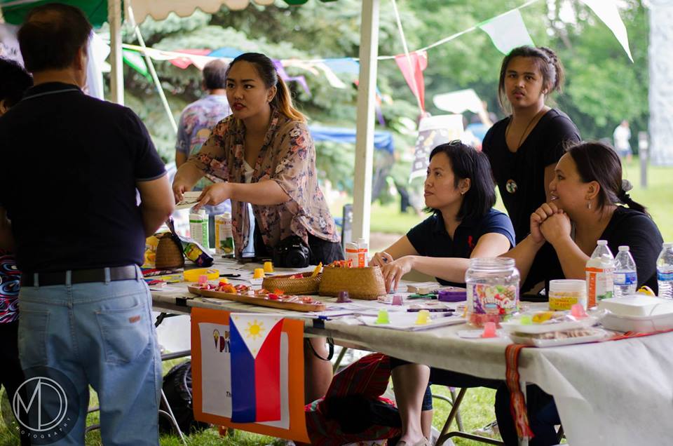 Image depicting volunteers Alpha Sadcopen, Oscar Docto, Loribelle Lorenzo, and Carollyn Lamen staffing a table at Piyesta Pinoy, spreading the word about The Field Museum's co-curation efforts.. Selected for use on the homepage of the Philippine Heritage Collectionsinteractive web portal. (c) Field Museum of Natural History - CC BY-NC 4.0