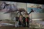 Evolving Planet staff Core Team (left to right): Richard Kissel (Content Specialist); Erica Kelly (Developer); David Quednau (2-D Design); Gretchen Baker (Developer); Eric Manabat (3-D 3D Design) standing by Parasaurolophus skeleton which is covered in plastic, Charles Knight paintings of Late Cretaceous Dinosaurs CK13AT and Upper Cretaceous Seas CK24_1T.