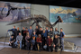 Group photo of selected Evolving Planet exhibit design and production staff.  Also smaller groupings shot of Evolving Planet exhibit design and production staff. 1. Robert Weiglein 2. Mark Kennedy 3. A. Nowak 4. David Mendez 5. Gretchen Baker 6. Richard Kissel 7. Erica Kelly 8. kballard 9. Eric Manabat 10. David Quednau 11. jjackson 12. Trigg Waller 13. Eric Frazer 14. Pat Bradley 15. bthompson 16. watylor 17. Sean Bober.  Parasaurolphus skeleton and group is standing under the, covered in plastic, Charles Knight paintings of Late Cretaceous Dinosaurs CK13AT and Upper Cretaceous Seas CK24_1T.