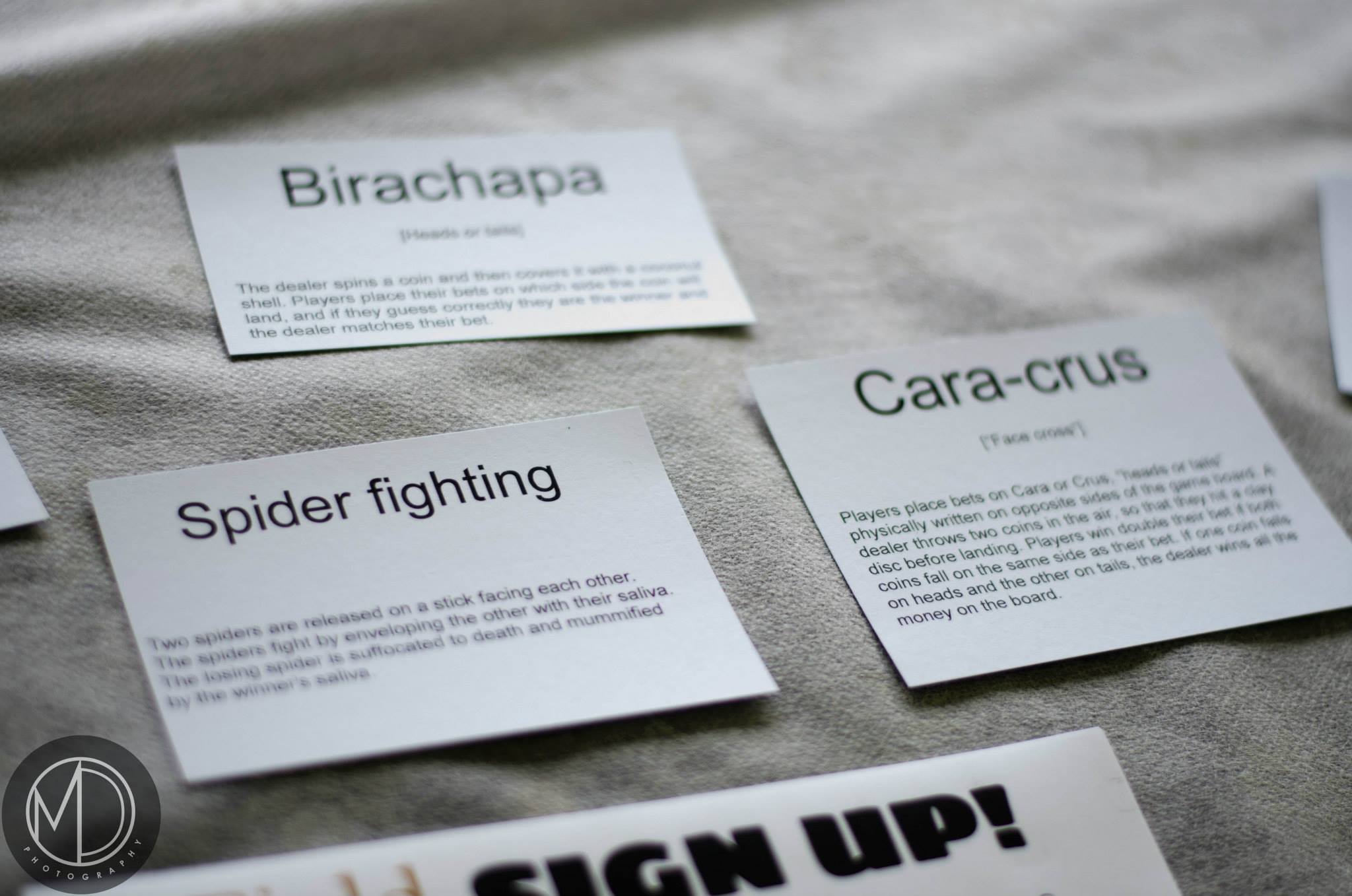 Close up of cards describing traditional Filipino games on The Field Museum's table in the Cultural tent. (c) Field Museum of Natural History - CC BY-NC 4.0