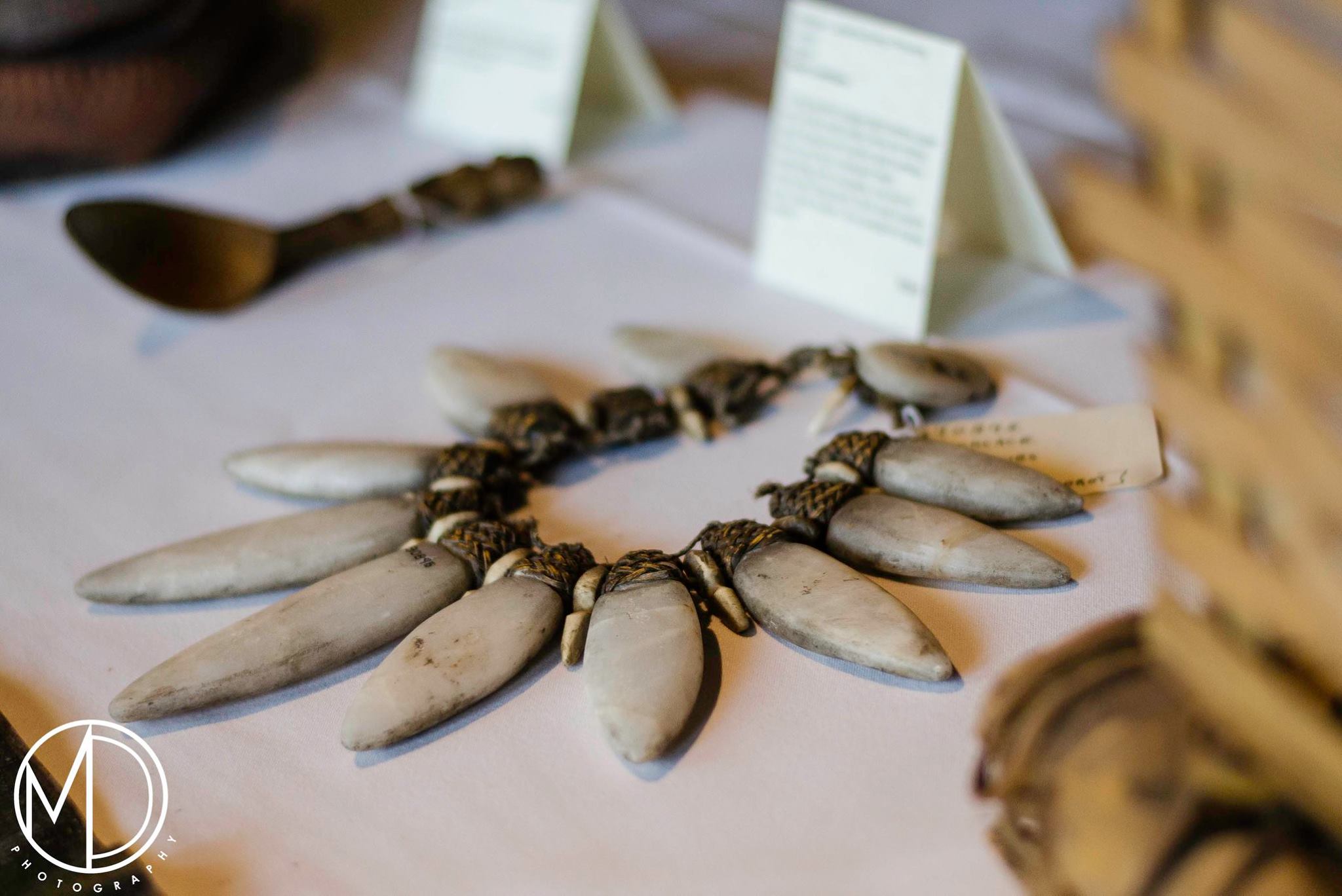 Close up of spoon, necklace, and spirit raft on display table. (c) Field Museum of Natural History - CC BY-NC 4.0