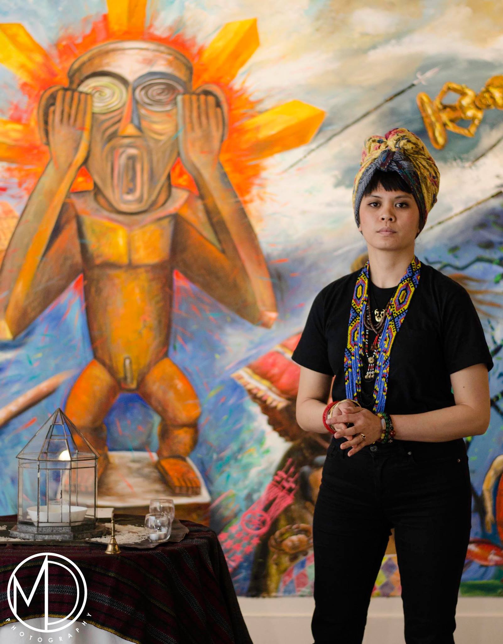 Volunteer standing next to altar for the bulol in the mural. (c) Field Museum of Natural History - CC BY-NC 4.0