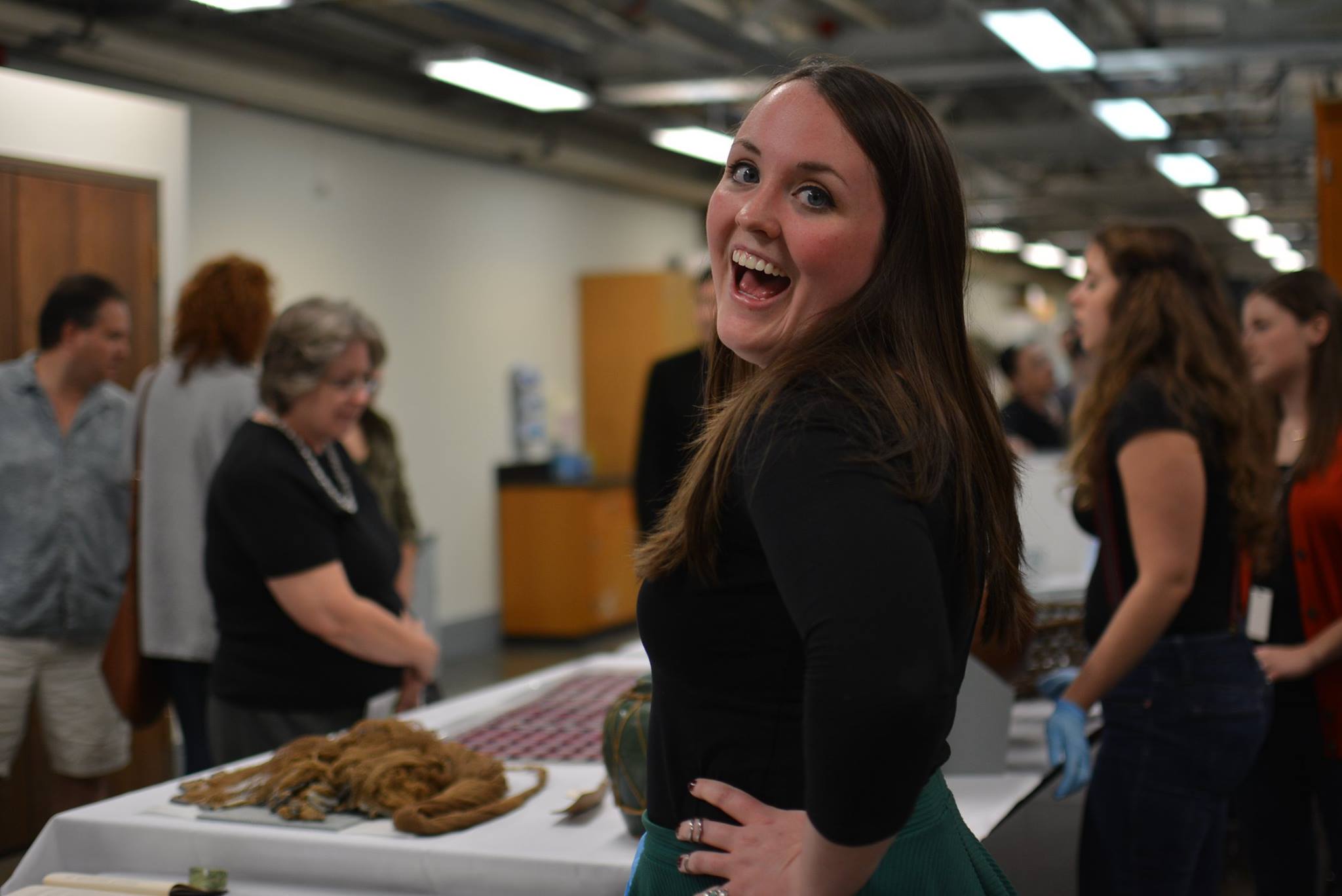 Liz grins excitedly as guests begin entering room 3805 to learn about the Anthropology collections at The Field. (c) Field Museum of Natural History - CC BY-NC 4.0