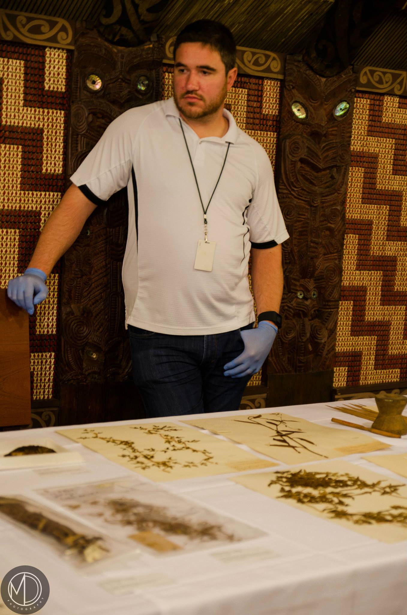 Dustin staffing the botanical specimen table inside Ruatepupuke II. (c) Field Museum of Natural History - CC BY-NC 4.0