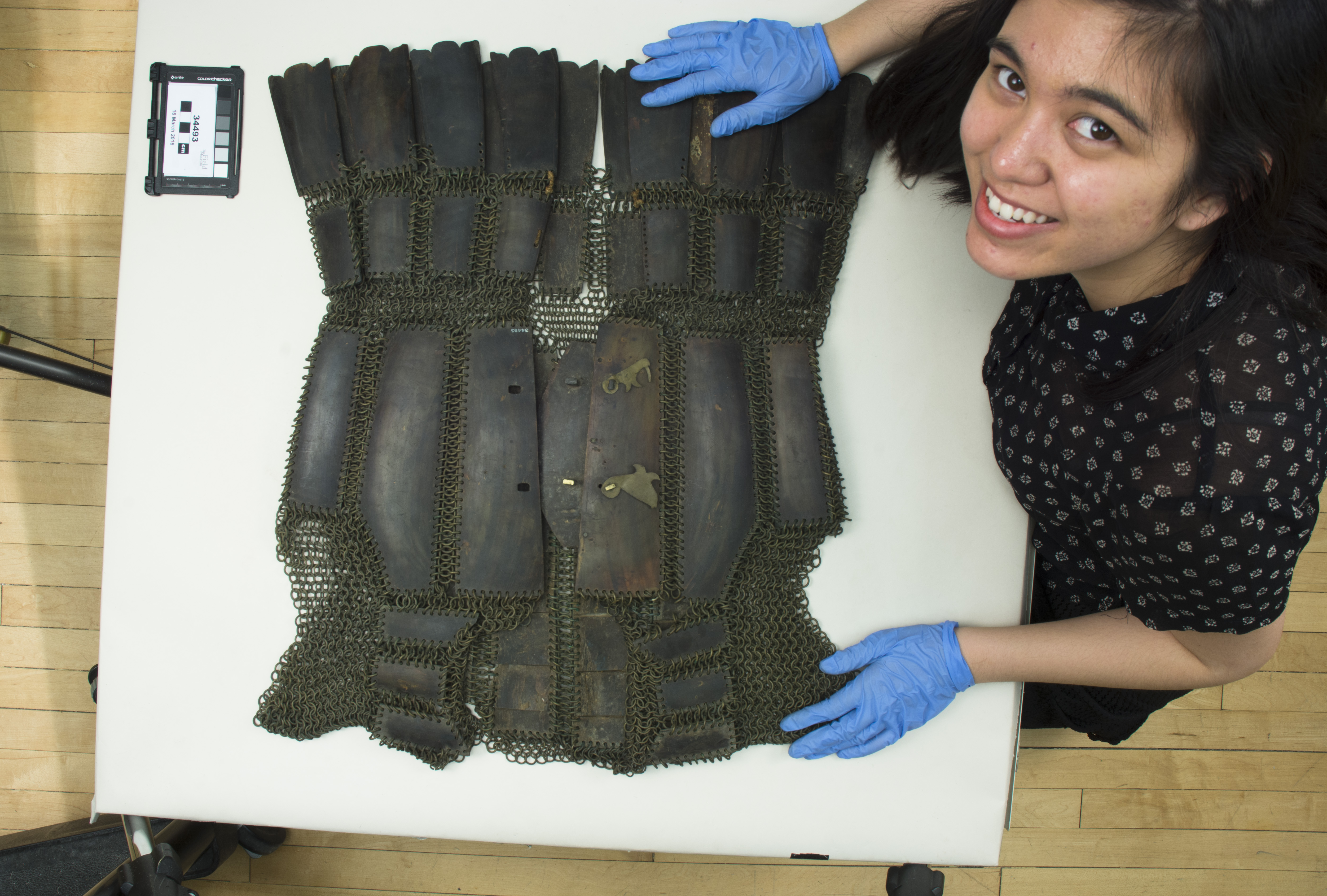 Loren photographing a suit of carabao horn armor. (c) Field Museum of Natural History - CC BY-NC 4.0
