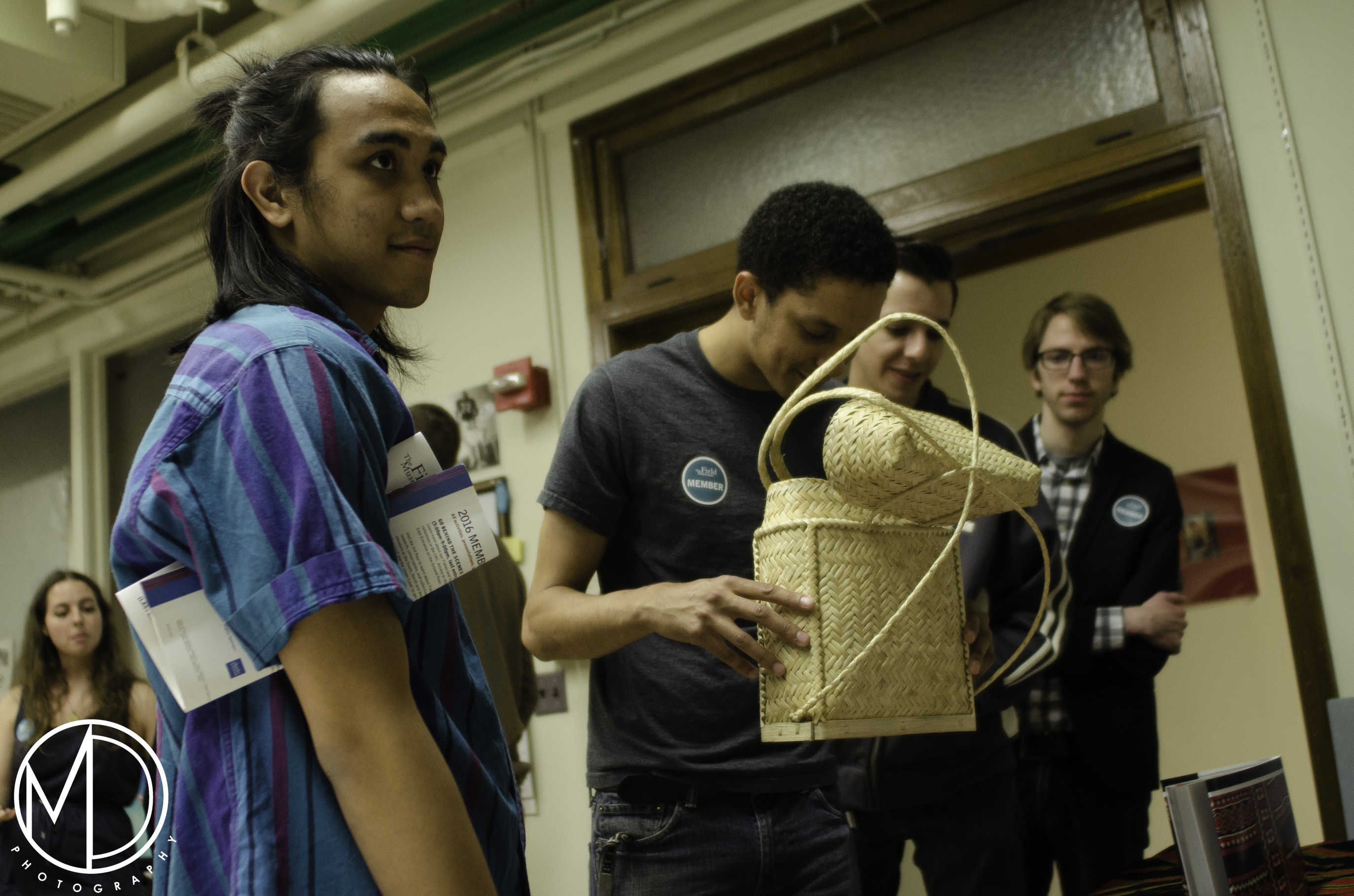 Guests getting a closer look at a non-collections piece from the Philippines. This pasiking is a modern version of historical ones present in the Philippines Collection. (c) Field Museum of Natural History - CC BY-NC 4.0