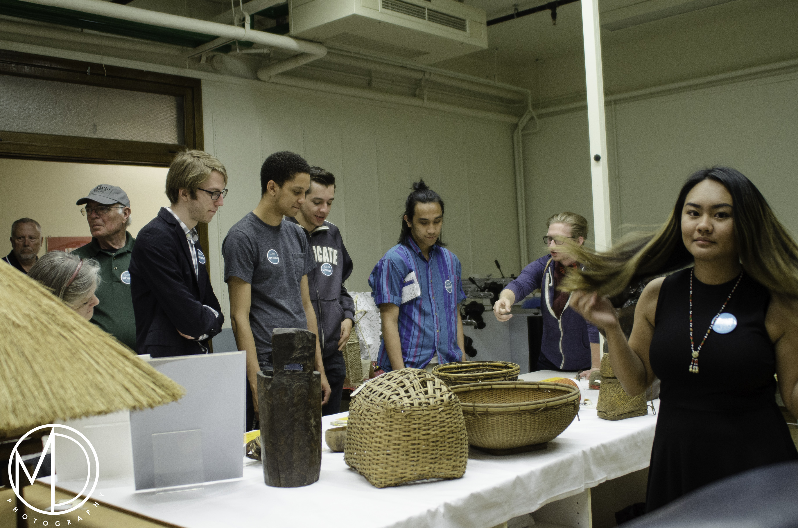 Guests approaching table of objects from the Philippines Collection. (c) Field Museum of Natural History - CC BY-NC 4.0