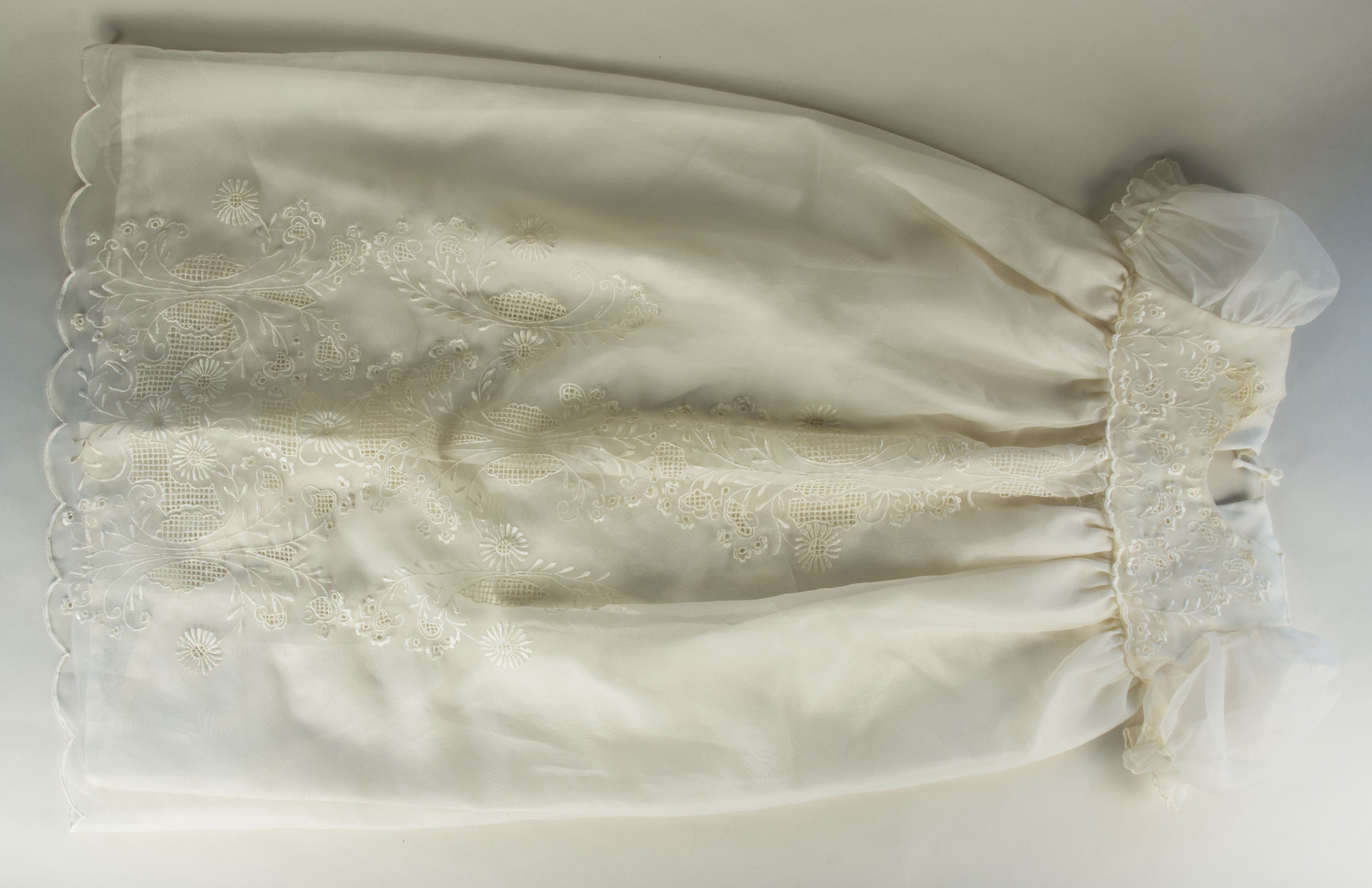 Baptism gown owned by Claudia Jamilla- front viewDaughter’s baptismal gown from 1997. Claudia  noted that this was probably made in southern Luzon. It was a gift from mother-in-law [the mother of Claudia’s husband; Stephanie’s grandfather. Symbolizes daughter’s [Stephanie’s] birth. Any views, findings, conclusions, or recommendations expressed in this story do not necessarily represent those of the National Endowment for the Humanities. (c) Field Museum of Natural History - CC BY-NC 4.0