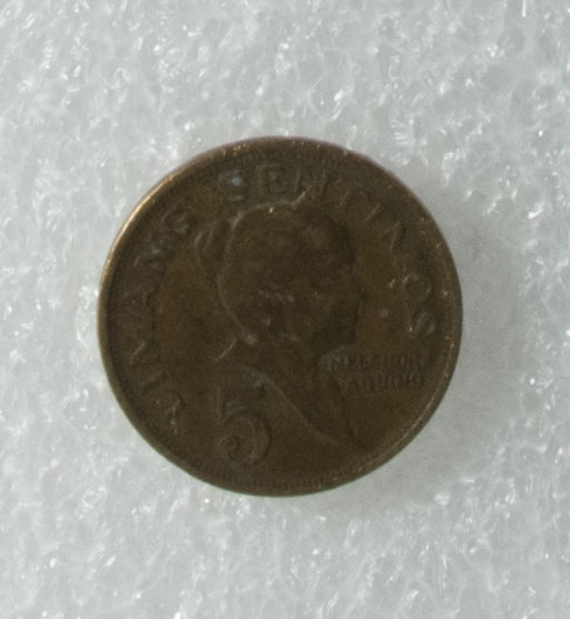 5c coin owned by Loribelle Lorenzo. Shows Melchora Aquino with the woman who sewed the Filipino flag. The coat of arms of the Philippines is on back. Words in Tagalog: “Republika ng Pilipinas”. Any views, findings, conclusions, or recommendations expressed in this story do not necessarily represent those of the National Endowment for the Humanities. (c) Field Museum of Natural History - CC BY-NC 4.0