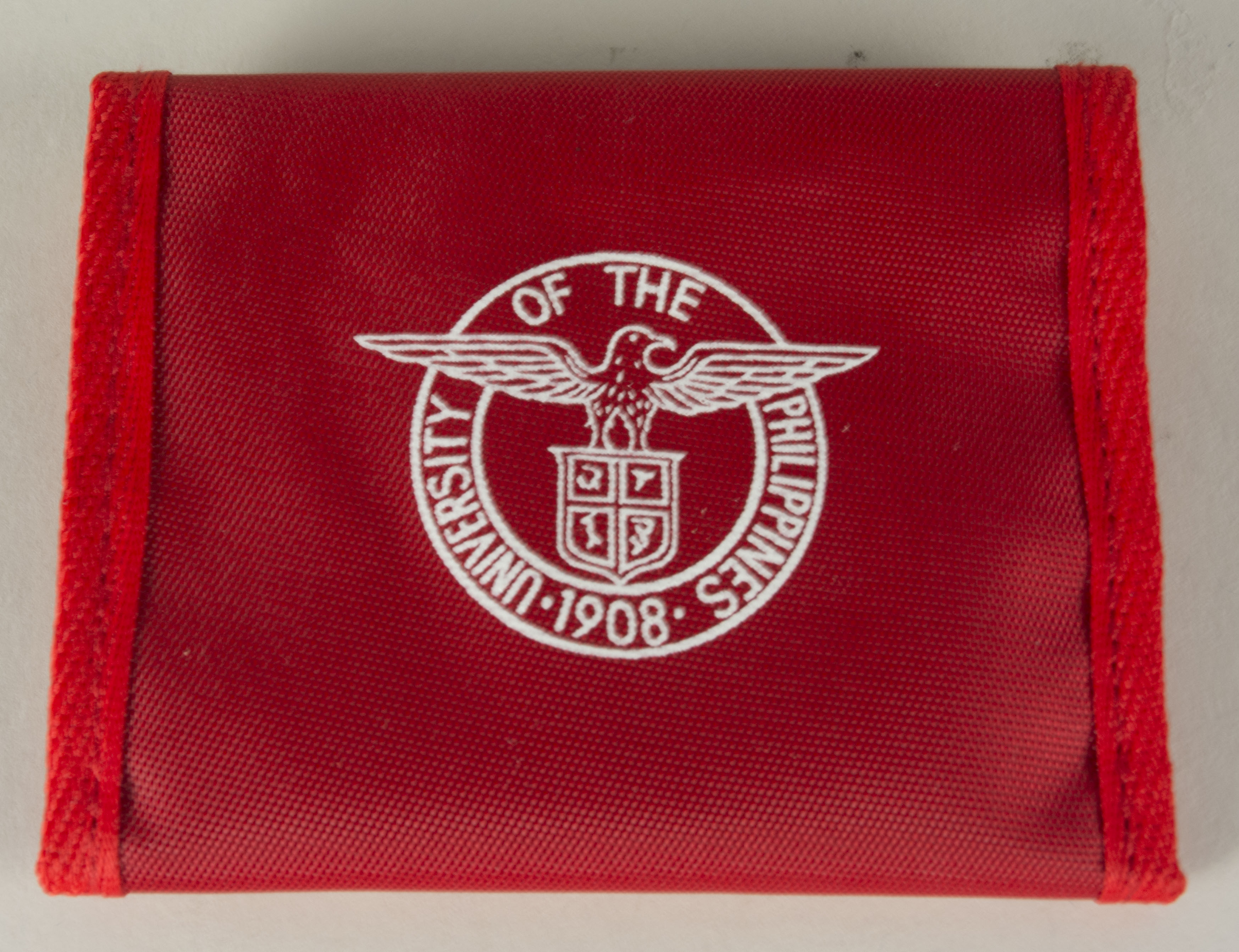 University of the Philippines wallet owned by SalazarSalazar said the objects were made in 2008 for the University of the Philippines centennial. They were gifts from a schoolmate, given to Salazar on a  visit to the Philippines. All writing on the objects is in English. Salazar said the university was a big part of his life.Between school and work, he was connected to the University for 11+ years. Salazar said he has fond memories and many close relationships from the University. Any views, findings, conclusions, or recommendations expressed in this story do not necessarily represent those of the National Endowment for the Humanities. (c) Field Museum of Natural History - CC BY-NC 4.0