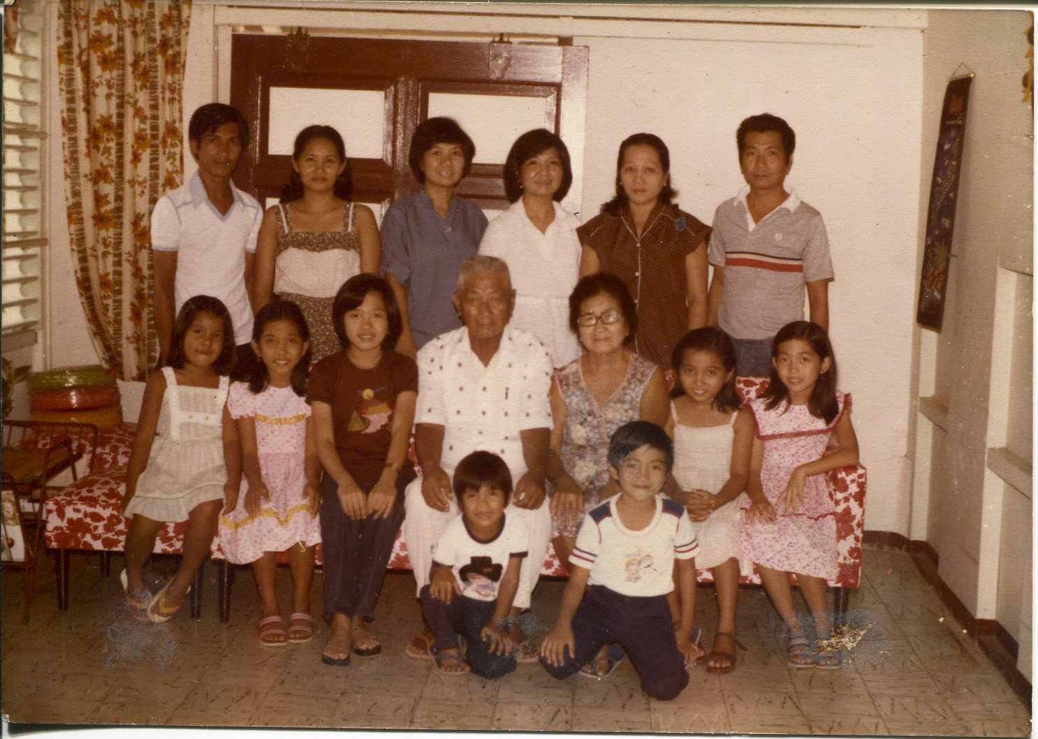 Photo of Escarilla-Carnate and family, 1980Taken in January 1980 in Iloilo City, in paternal grandparents’ house by a professional photographer. Pictured are the grandparents, children, and grandchildren except 2 of her siblings who were born later.Escarilla-Carnate says the family speaks English and Tagalog, and the Ilongot dialect called Hiligaynon which has a “melodious” tone compared to Karay-a which is “harsh/harder” in tone.Escarilla-Carnate said, “This photo is significant because family is important and I am very close with siblings and cousins. Every Sunday, we have lunch or dinner with grandparents. These are good memories. Every Sunday after mass, my dad or or grandpa would stop bymarket to buy fresh meat, thin pork chops (no vegetables). Only one piece of liver was delivered on Sundays. There was no supermarket. We used vinegar and chili dip. The menu was always the same every Sunday.” Any views, findings, conclusions, or recommendations expressed in this story do not necessarily represent those of the National Endowment for the Humanities. (c) Field Museum of Natural History - CC BY-NC 4.0