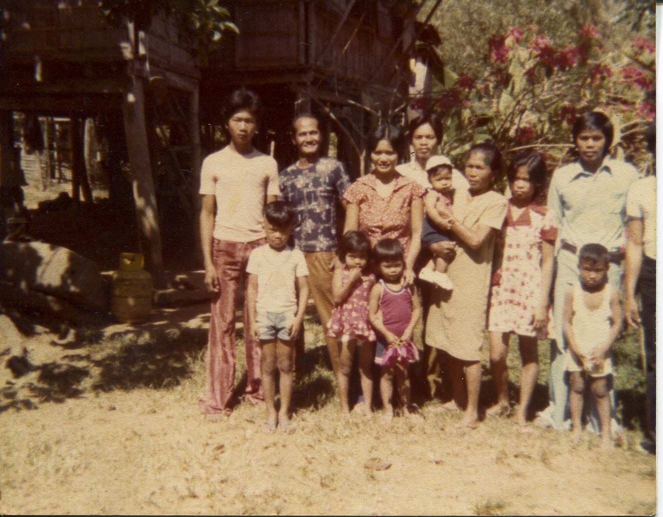 Photo of Carnate's family, unkownUnknown date, from own photo collection. Taken at childhood home in Tangcarang. Left to right back row: neighbor, uncle Epifanio Domingo, sister Milagros Carnate, neighbor, brother Jesus Carnate, brother in law Generoso Cadiente (married to Milagros)Front row: unknown, Genalyn and Joelle (daughters of Milagros and Generoso,) unknown children (nieces.) Any views, findings, conclusions, or recommendations expressed in this story do not necessarily represent those of the National Endowment for the Humanities. (c) Field Museum of Natural History - CC BY-NC 4.0