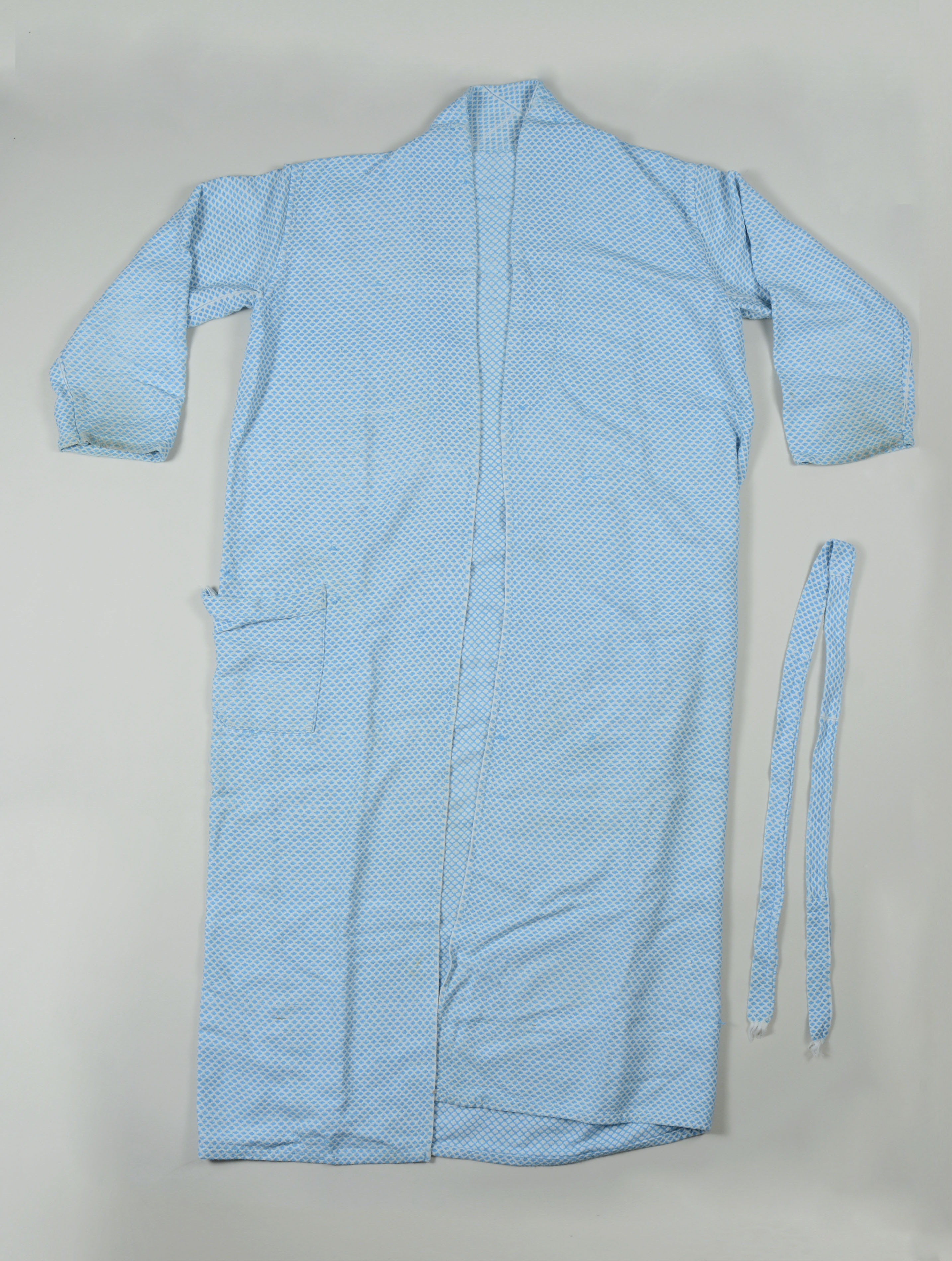 Abel Iloko (Hand woven) bath robe owned by Edwin P. Abaya- full.  Made in the 1960s and given to Edwin by his mother, who had the robe custom made for him. It was made in Vigan, Ilocos Sur. He brought it with him when he came to the US in 1968. It is important to Edwinbecause hand woven clothing and other products are and have been a thriving industry in Ilocos Sur and he does not know if we have any examples of this work in our collection at the Field Museum. He wants to make sure they are represented. He says the design is slightlyunusual for the time, as they were usually more geometric. He does not wear it anymore because he wants to preserve it. He says he is grateful that this project (Homeland Memories) exists for the people who came to the US from the Philippines and wants to contribute these 2objects to show what his hometown is known for. Any views, findings, conclusions, or recommendations expressed in this story do not necessarily represent those of the National Endowment for the Humanities. (c) Field Museum of Natural History - CC BY-NC 4.0
