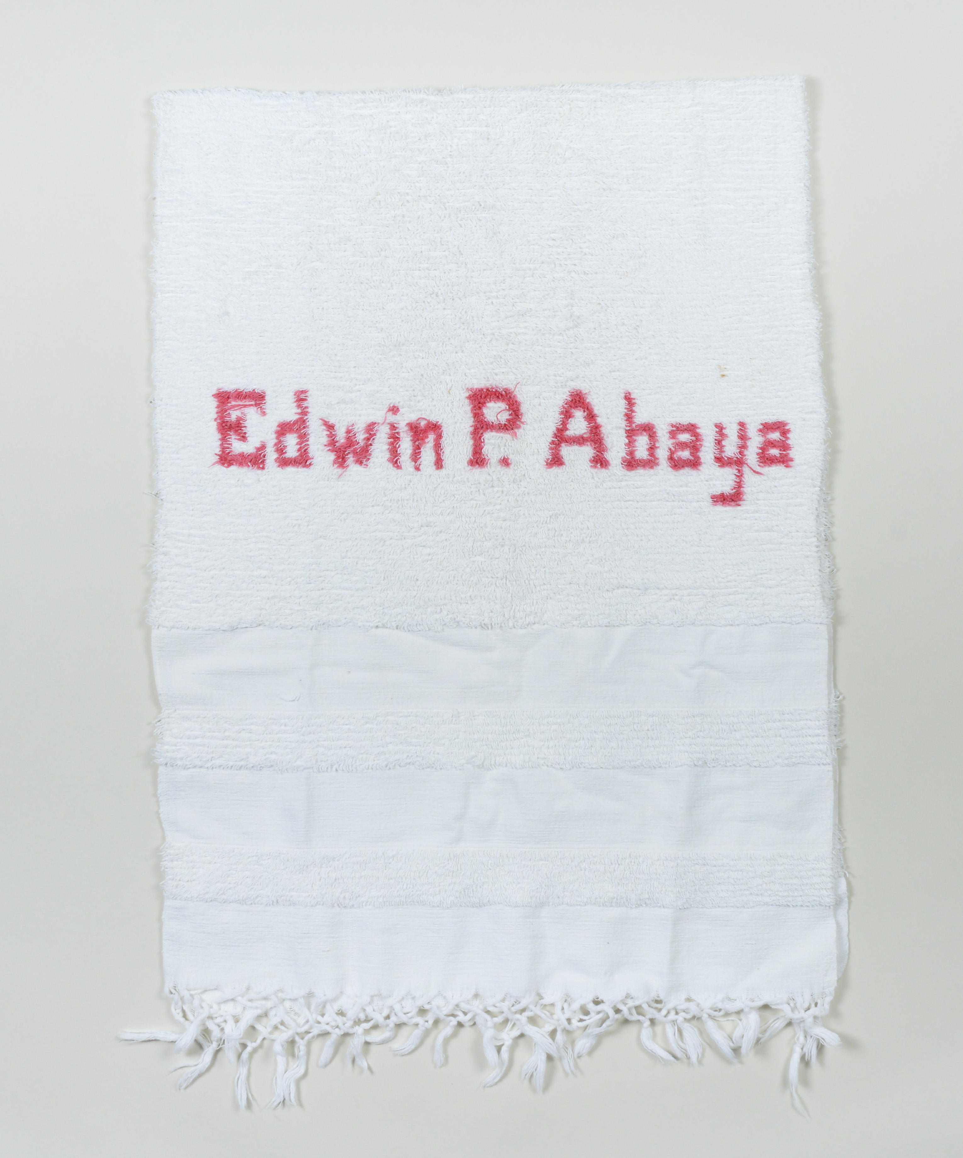 Abel Iloko (Hand woven) bath robe owned by Edwin P. Abaya.Made in the early to mid 1960s; given to Edwin by his mother in the mid 1960s. He left the Philippines in 1968 and brought this towel with him because his mother had passed away by then and it is a keepsake from her. It was the only monogrammed object he had, and he likesthat it looks like such quality work and they “didn’t misspell my name.” Vigan, Ilocos Sur, was known for hand weaving; they make clothing, towels, pashminas, etc. still today. Any views, findings, conclusions, or recommendations expressed in this story do not necessarily represent those of the National Endowment for the Humanities. (c) Field Museum of Natural History - CC BY-NC 4.0