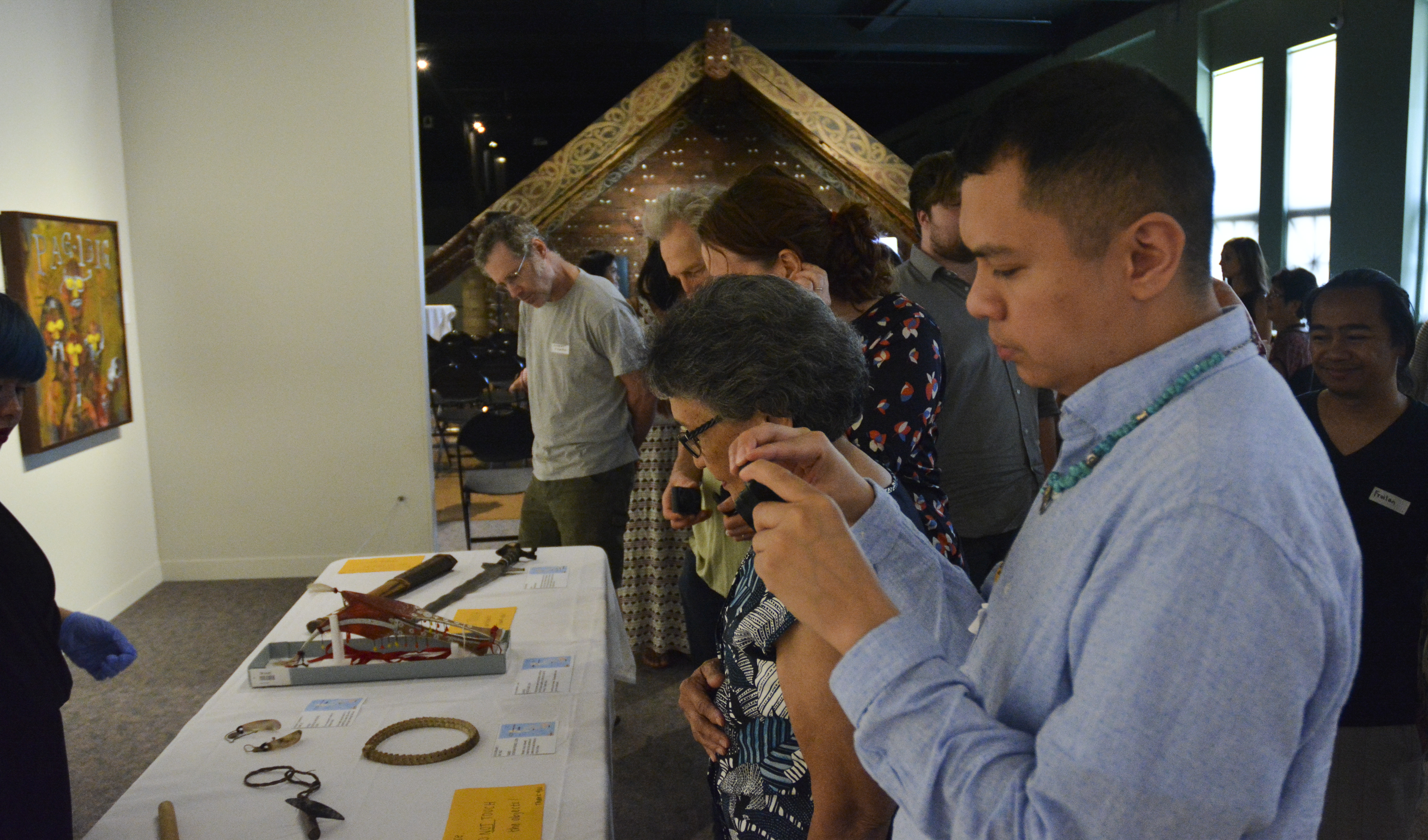 Anthonie Tupmag photographing Philippine objects on the table. (c) Field Museum of Natural History - CC BY-NC 4.0