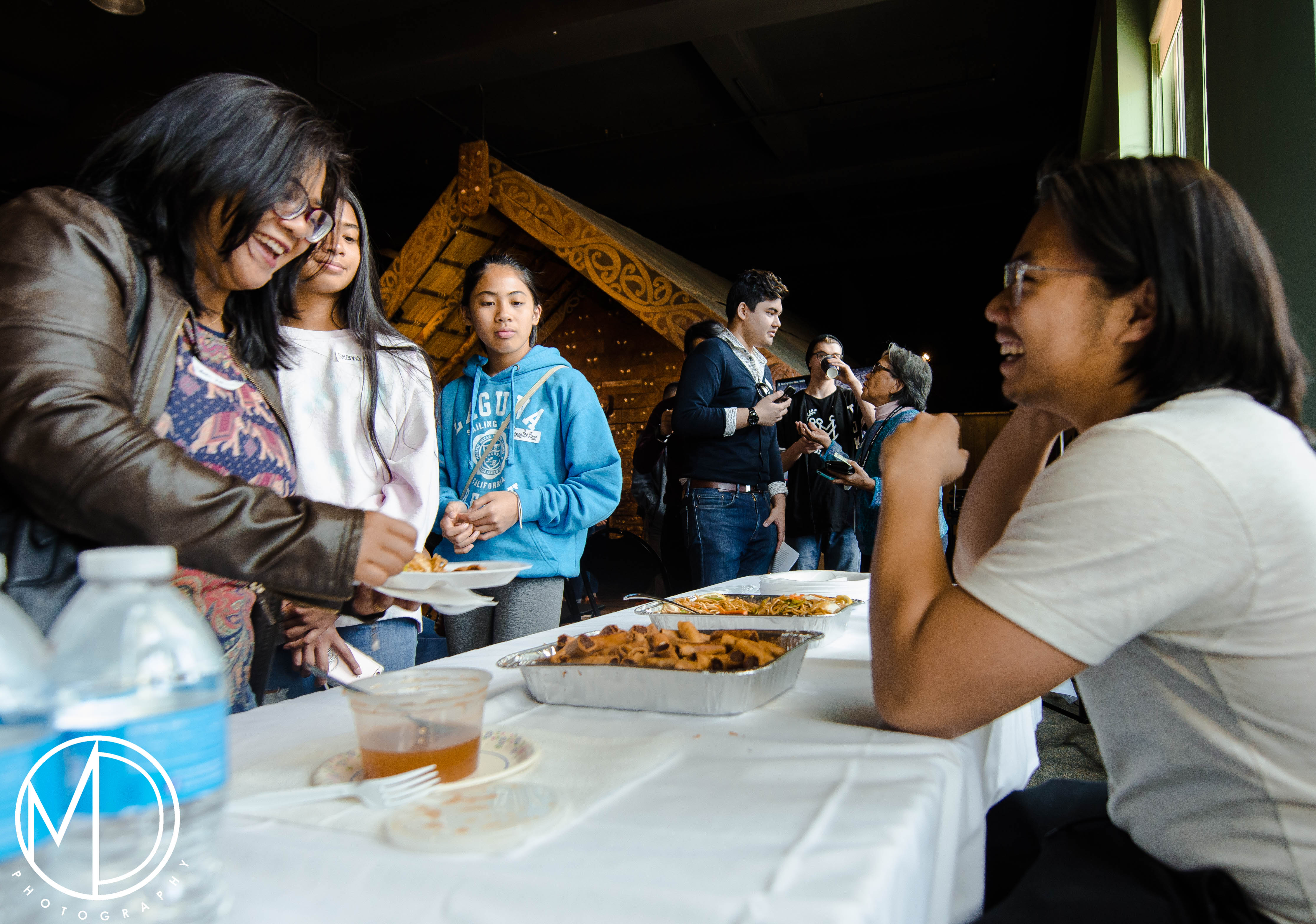 Tristan Espinoza interacting with guests by the food table. (c) Field Museum of Natural History - CC BY-NC 4.0