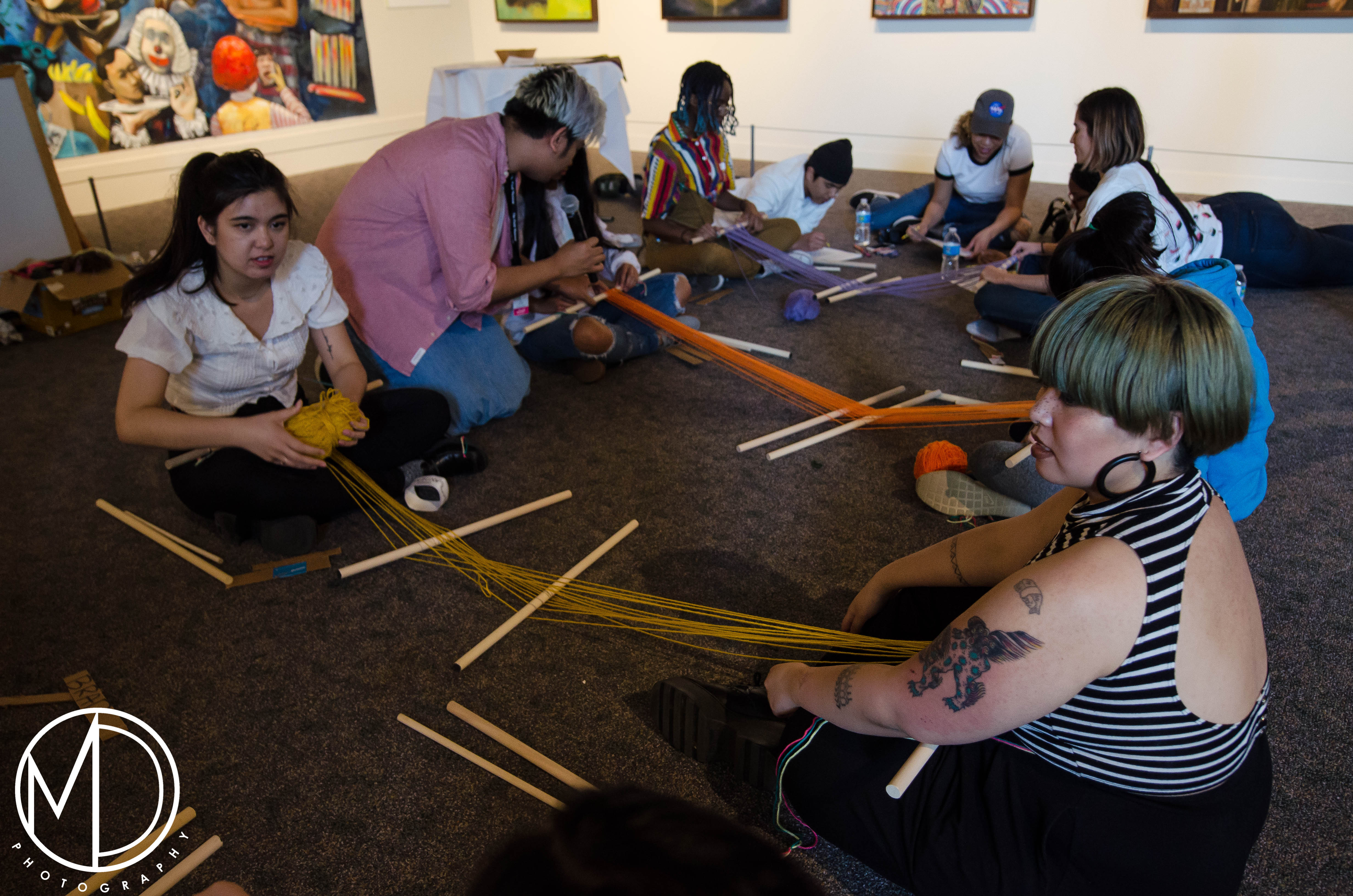 Loren Ibach and Avigail Bautista teaching guests about weaving with a backstrap loom. (c) Field Museum of Natural History - CC BY-NC 4.0