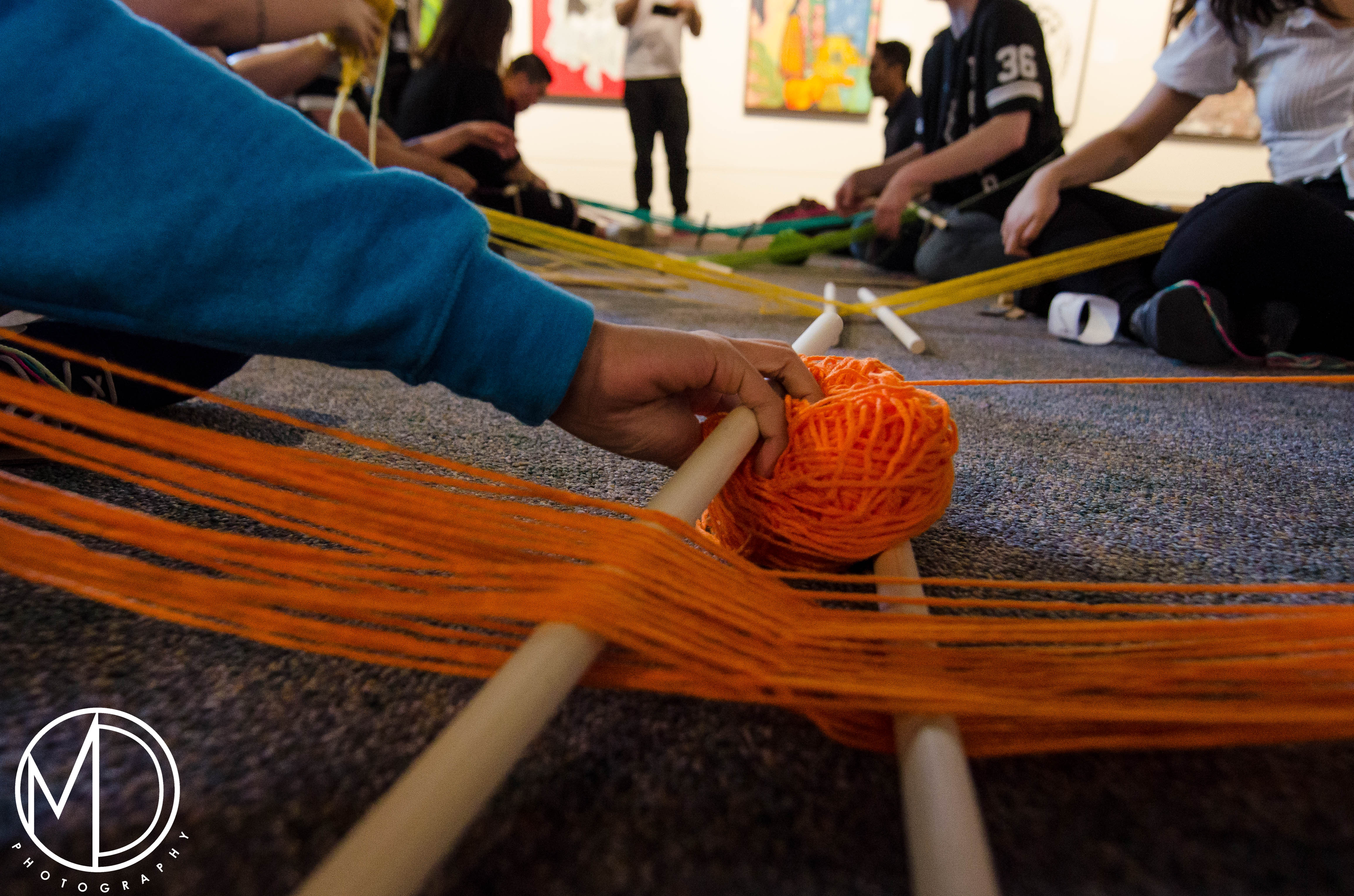 Guests participating in the weaving activity. (c) Field Museum of Natural History - CC BY-NC 4.0