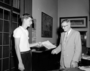 Konrad Banasak, teenage boy presenting a written report to John Millar in Director's office.  For Raymond Foundation, Museum Journey program related to Voyage of the Beagle, Darwin. Calendar on wall, September 1959 Stanley Field's (Founders' Room). Shows framed architectural drawing [blueprint] of Field Museum exterior.  See CSGN24130 and Poster Map of the Races of Mankind, Malvina Hoffman.