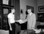 Konrad Banasak, teenage boy presenting a written report to John Millar in Director's office.  For Raymond Foundation, Museum Journey program related to Voyage of the Beagle, Darwin. Calendar on wall, September 1959 Stanley Field's (Founders' Room). Shows framed architectural drawing [blueprint] of Field Museum exterior.  See CSGN24130 and Poster Map of the Races of Mankind, Malvina Hoffman.