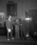 Stanley Field, Clifford C. Gregg, and John Ladd of New York City, the 20,000,000th visitor, in Field's office. Ladd was given a gift of a miniature Malvina Hoffman bronze sculpture of a Vedda woman.  In background of office is the Charles R. Knight Irish Deer study painting on wall and (barely visible) Carl Akeley miniature bronze sculpture of elephants on table with several photographs, behind them.