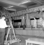 Preparing the educational television program "Down to Earth" with New Trier High School Students and Ernest Roscoe, Raymond Foundation with Mrs. Penny Kneipper, a sixth grade teacher in Wilmette. The Audio Visual [AV] project filmed with movie cameras, microphones and two student moderators.  Charles Knight murals in background, fossil exhibits in Hall 38.