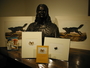 John James Audubon bust held by the Library. An arrangement of books and prints with the sculpture.