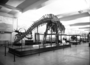 Brontosaurus skeleton, without skull and vertebrae, exhibited in Hall 38. Fossil Vertebrates. Charles Knight murals in background.