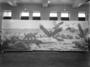 Rancho La Brea Tar Pools (Smilodon) Cenozoic; Charles Knight painting or mural. A Pleistocene panorama set at an asphalt pitch pool in Los Angeles California. Large bird Teratornis, sabertooth cat Smilodon, and an extinct species of horse. Preinstallation, not installed, windows of Hall 38 in background, the painting is on the floor.