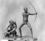 Bushman Family group. Life-size full length figures. Man, Woman, Baby. Front view of hunter with a bow and arrow, his wife and baby, child strapped to its mother's back. Beside the mother are three ostrich eggs for carrying water. Bronze Sculpture by Malvina Hoffman.