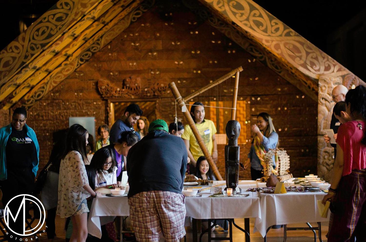 Guests viewing the artifacts displayed on tables. 