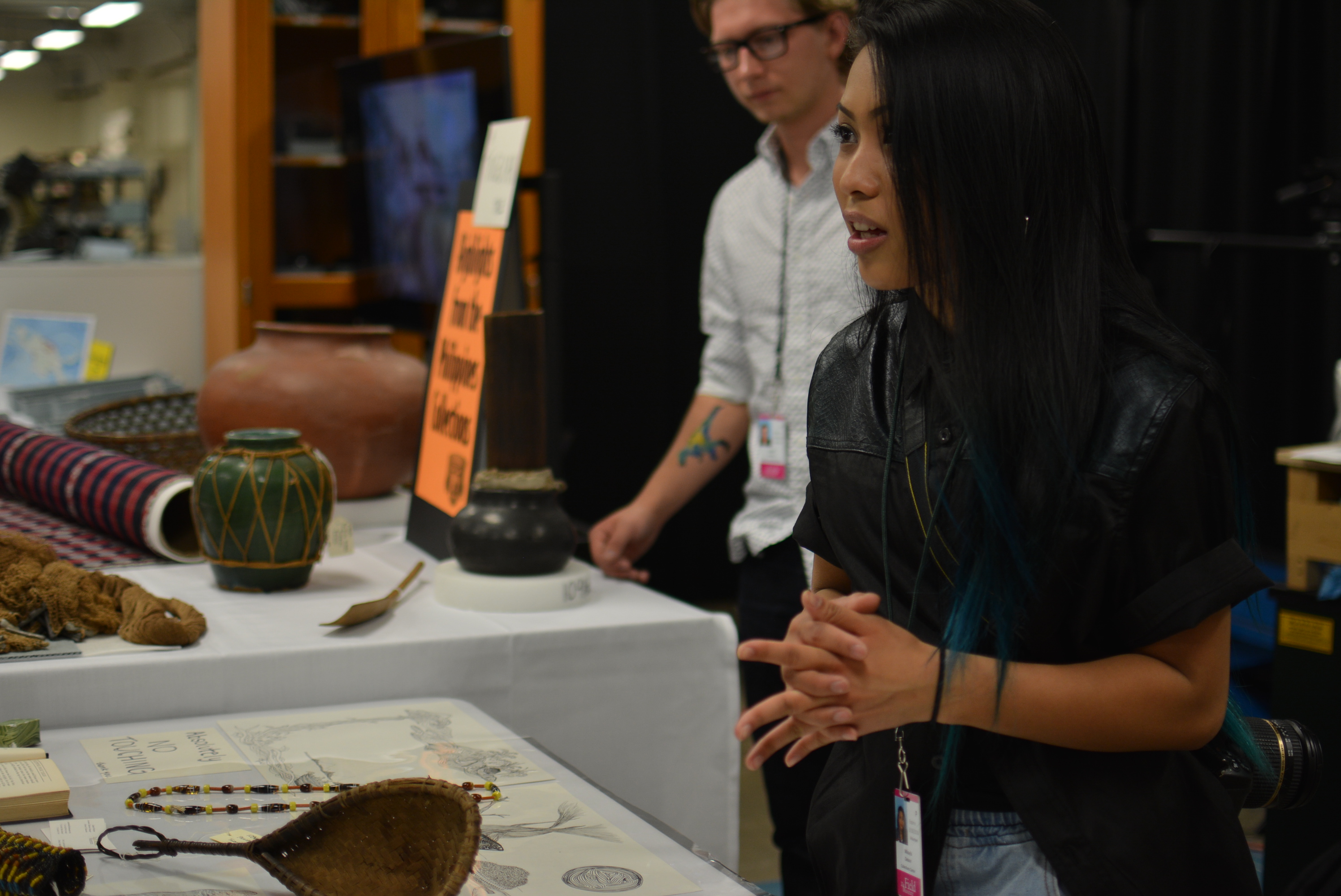 Mikayla answers guests' questions about the artifacts on display. 