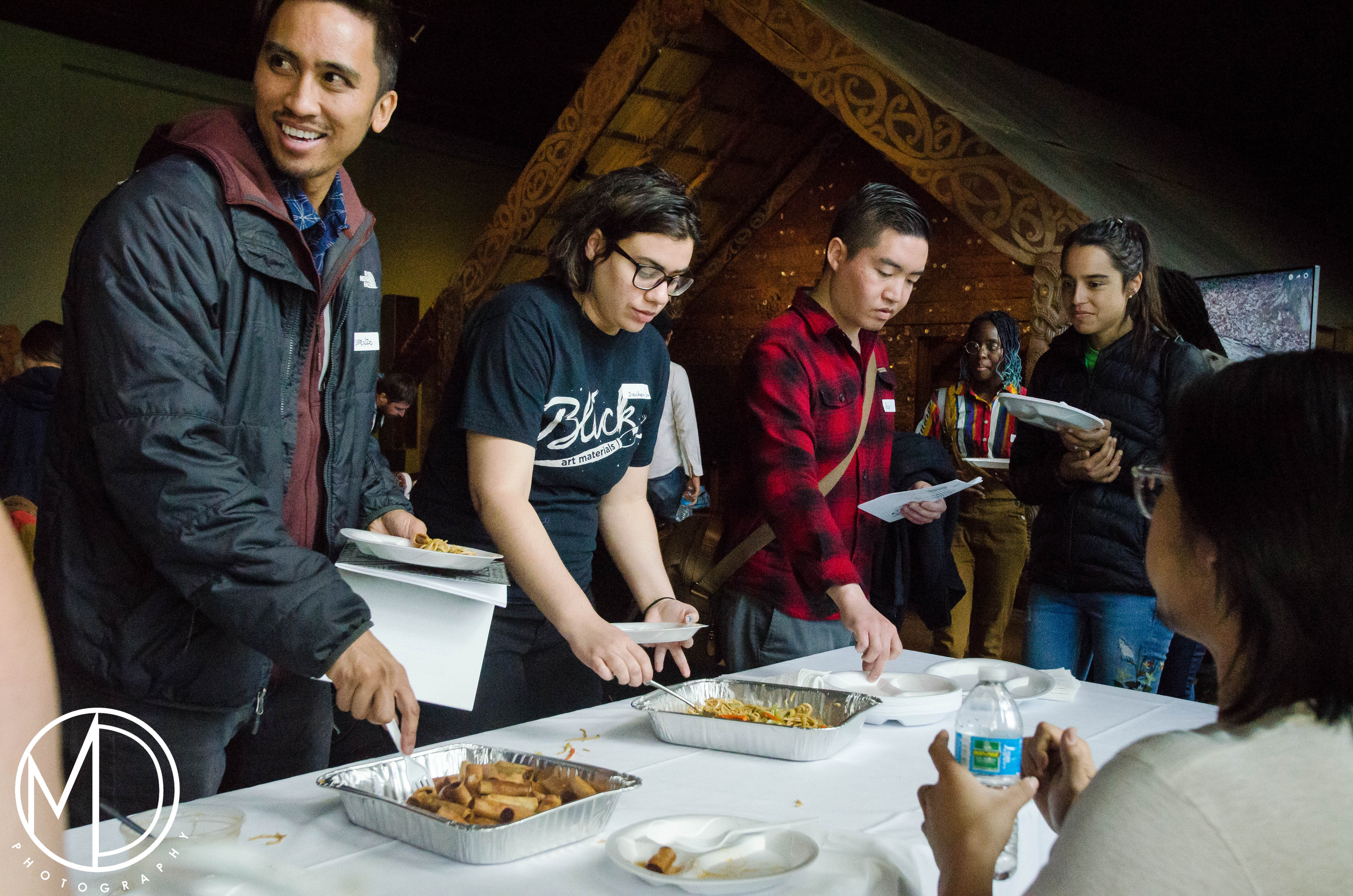 Guests trying out lumpia (Filipino egg rolls). 
