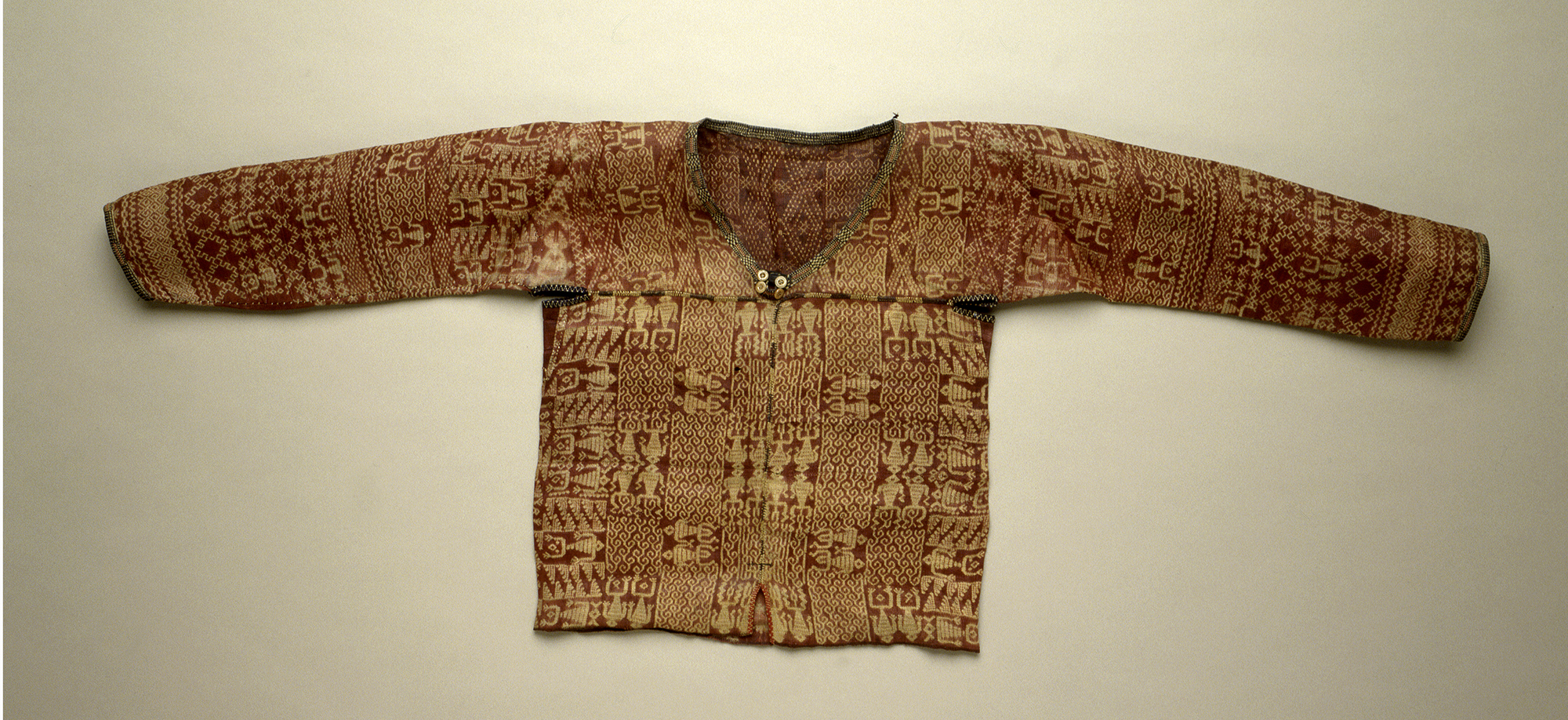 Kulaman abaca tritik shirt for mabolot war leader.  One loom narrow width of cloth forms the lower part of the bodice, separate pieces form the shoulders and sleeves. Larger garment can be made for a man. 