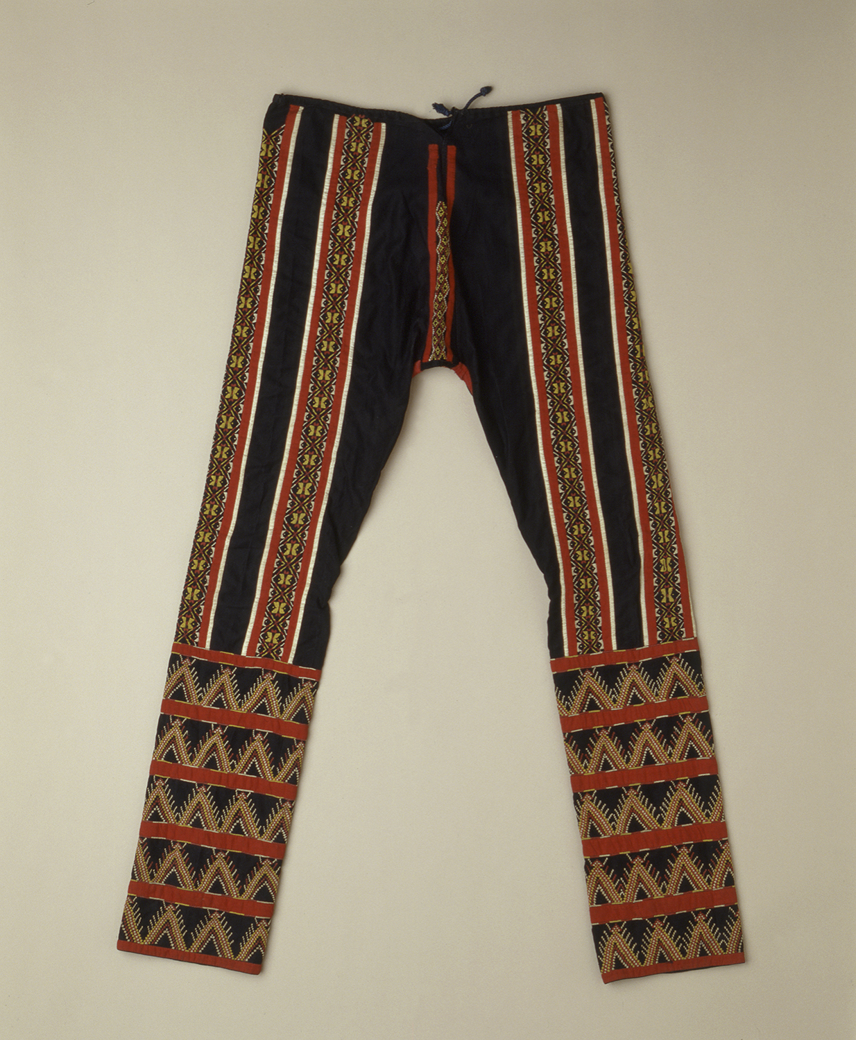 man's pants with applique and embroidery on cotton trade cloth.  Name recorded by collector Fay-Cooper Cole, saloal. 