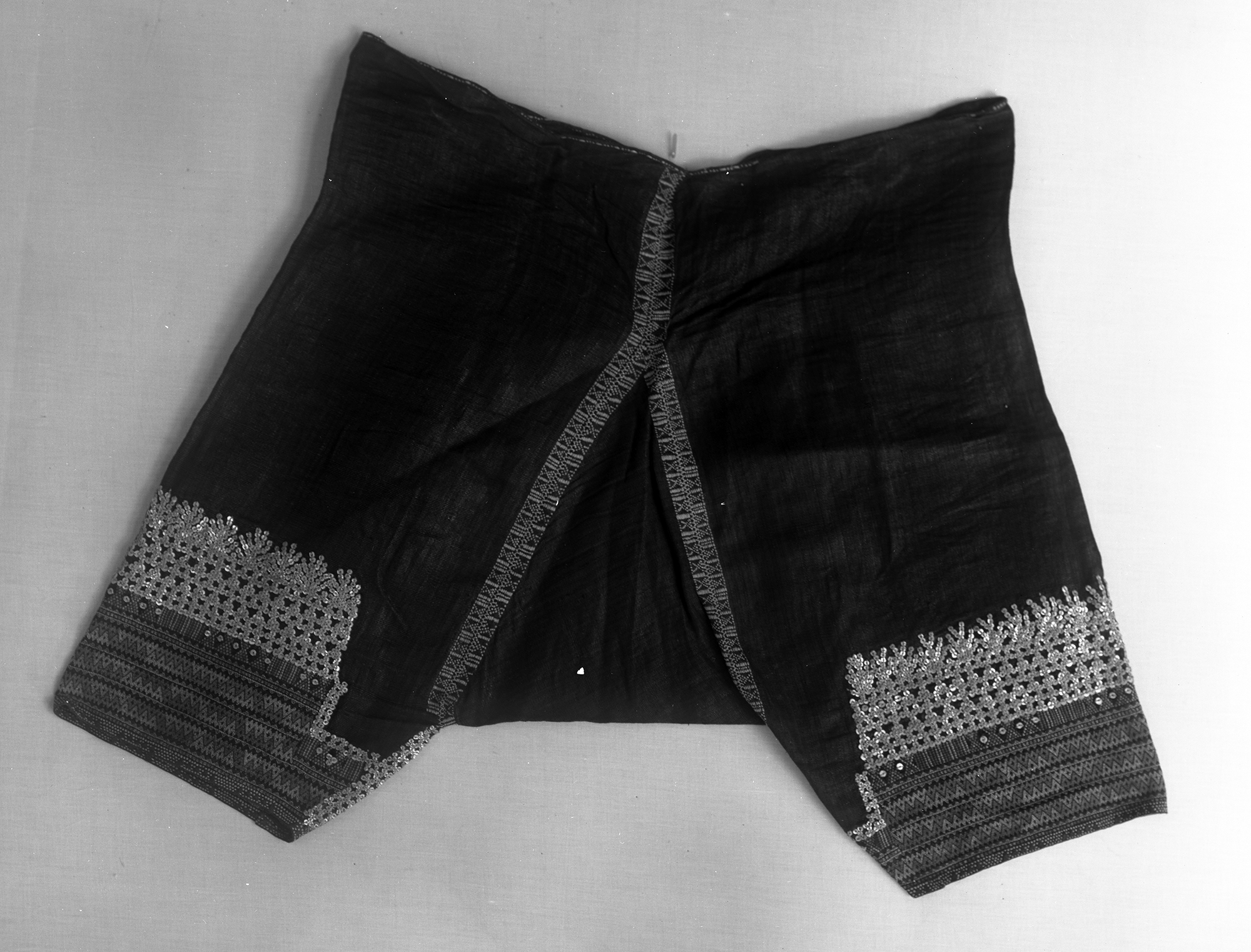 Men's trousers decorated with embroidery and shell disks.  Specimens. hemp, shells, embroidery 